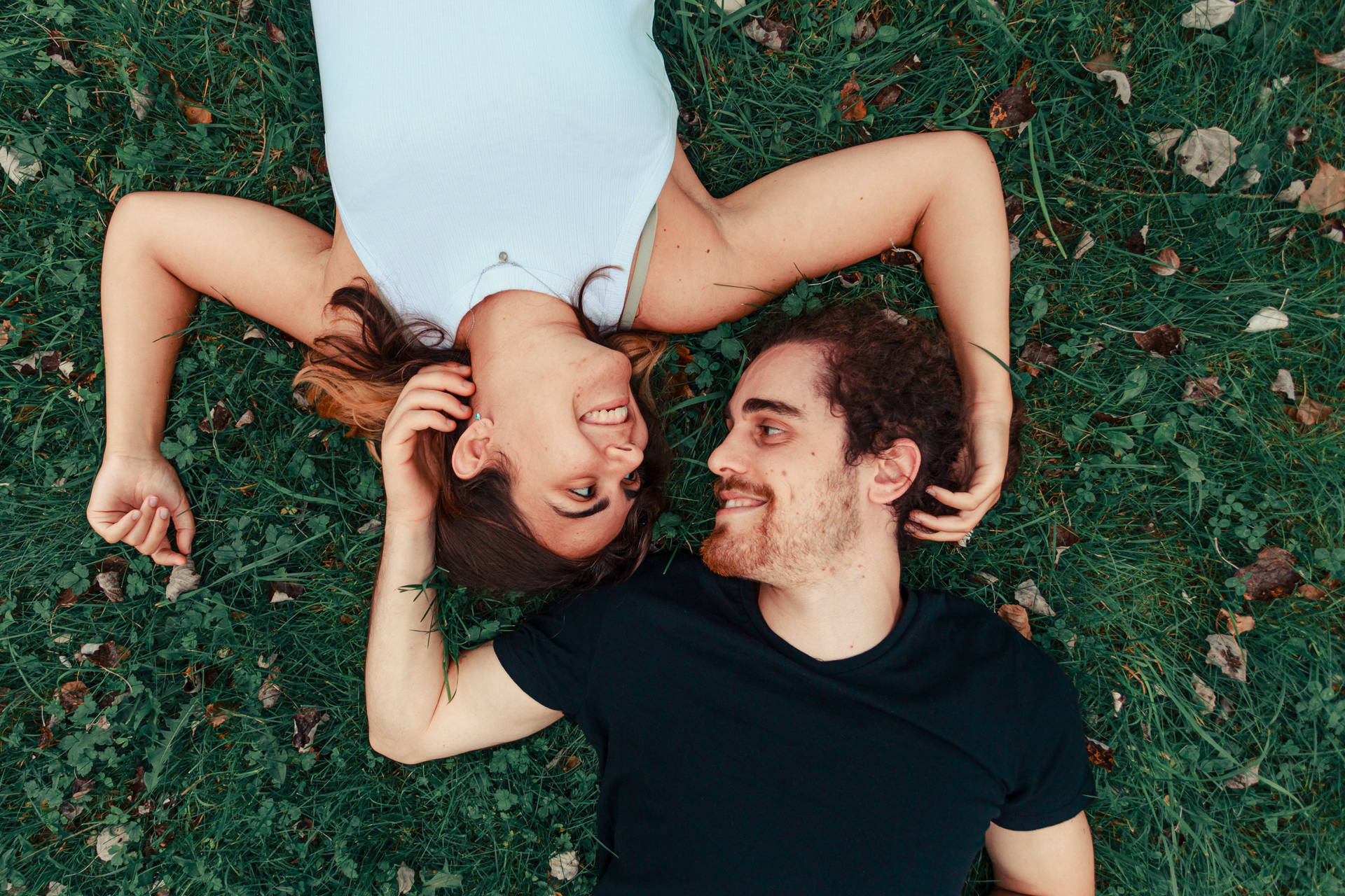 Romantic Couple Lying On The Ground Wallpaper