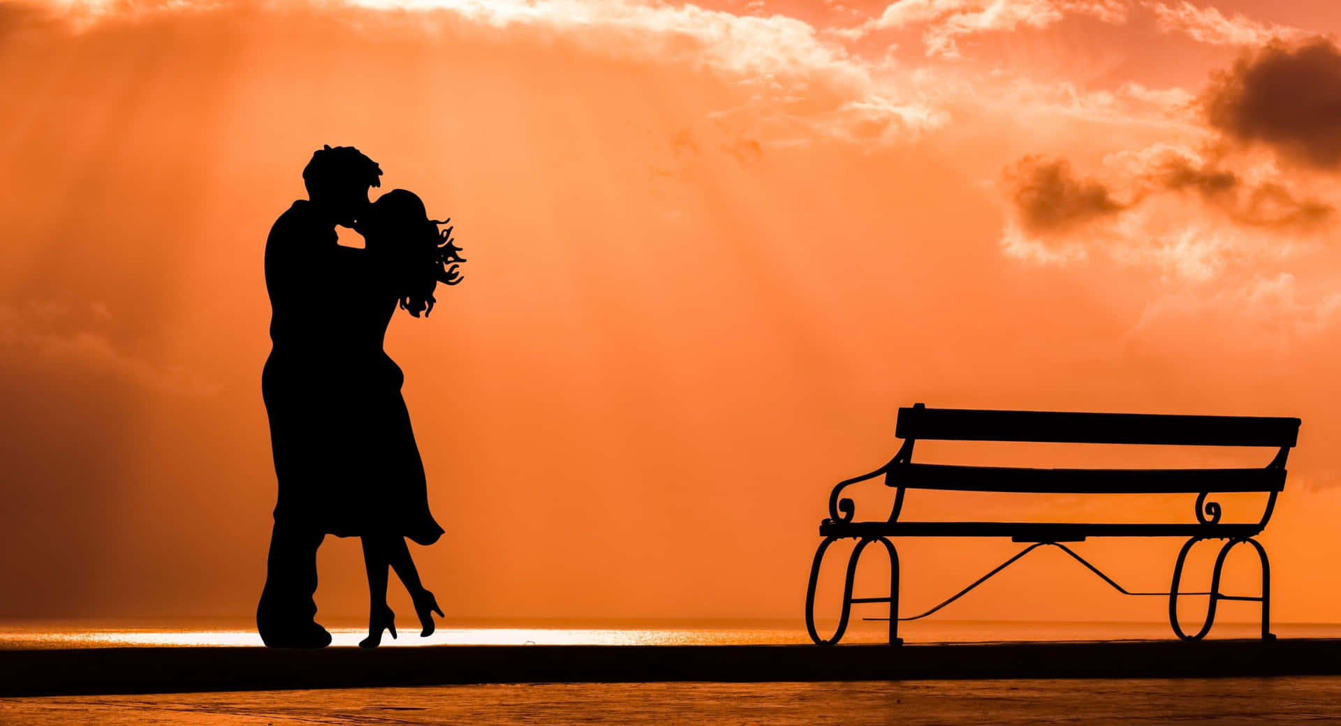 A romantic couple embracing and enjoying the sunset
