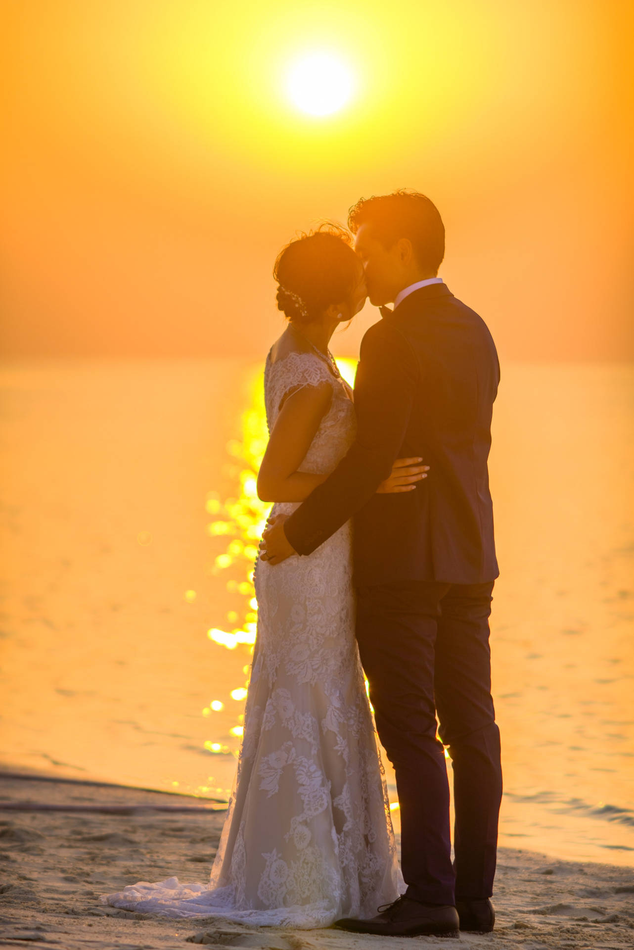 Romantic Couple Sunset Wedding Kiss Wallpaper