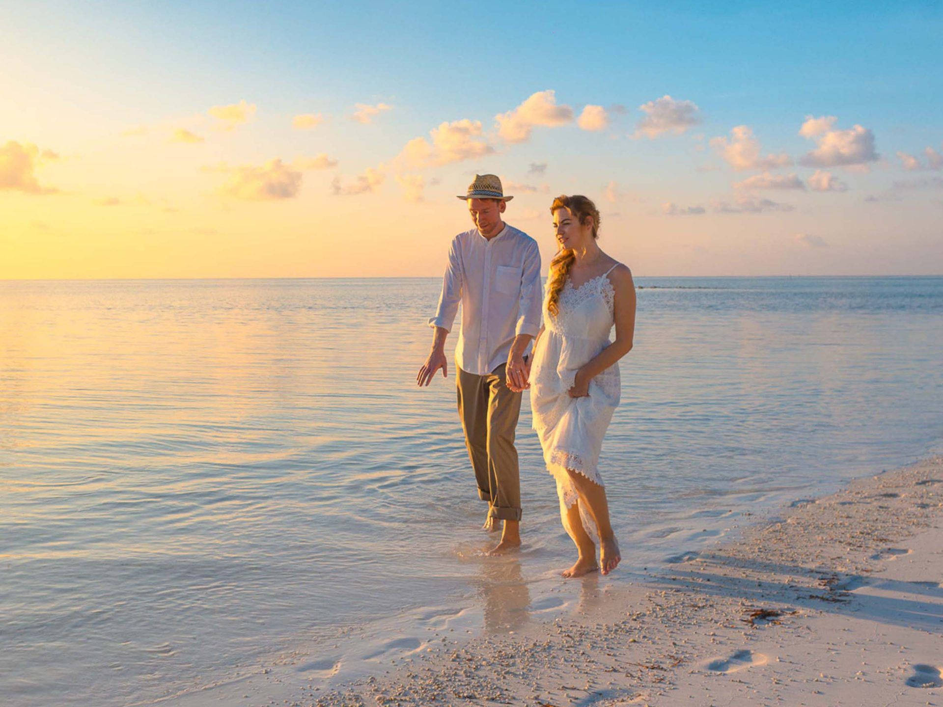 "romantic Getaway: A Couple's Tranquil Moment On The Beach" Wallpaper