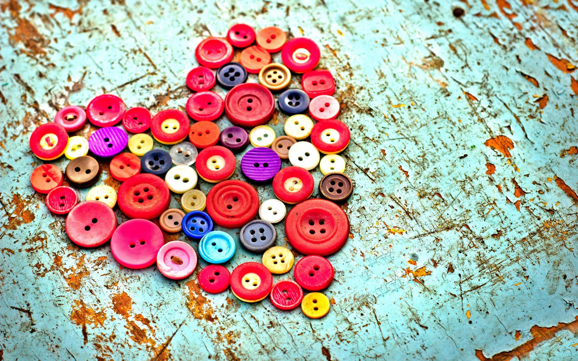 A Heart Made Of Buttons On A Wooden Surface