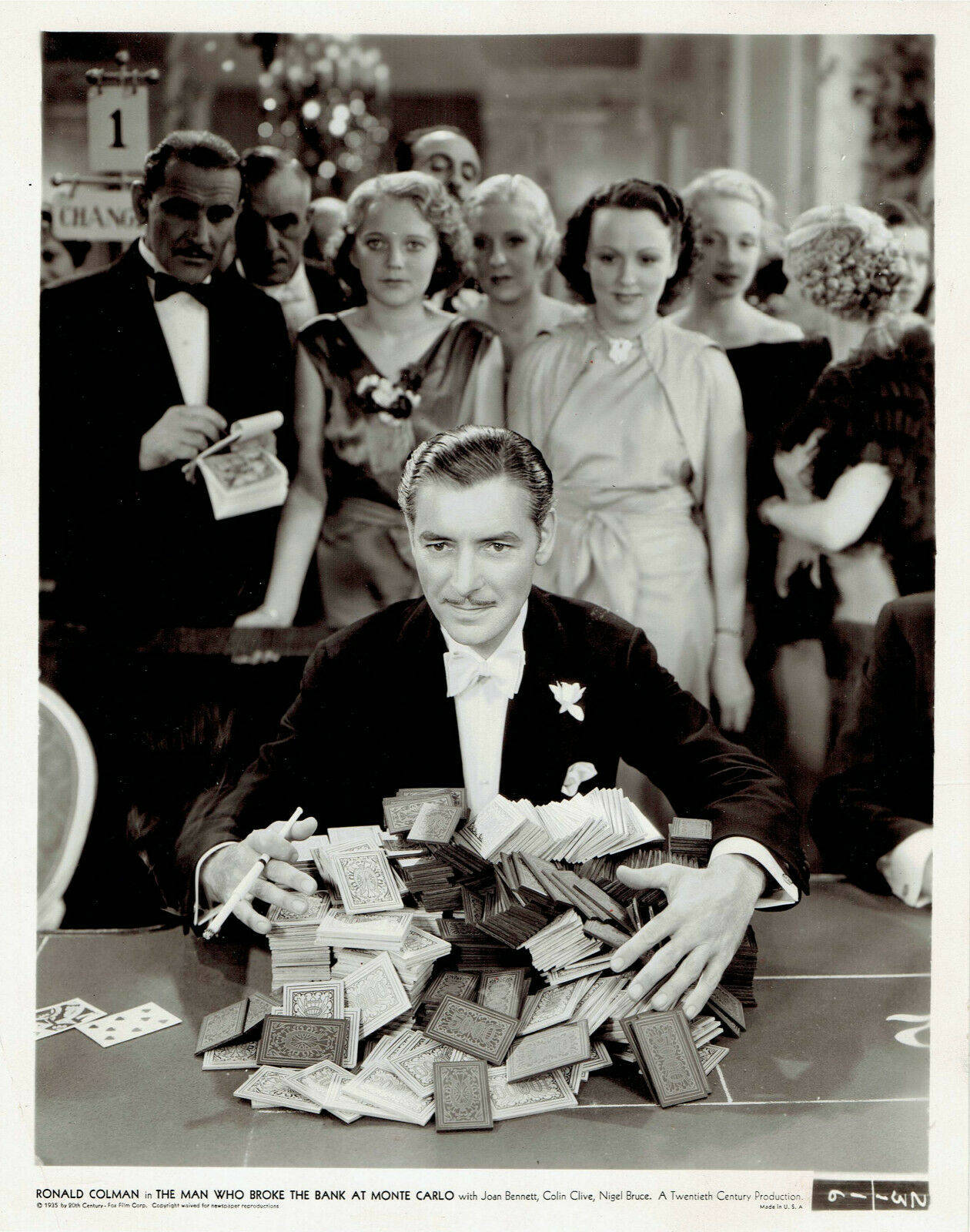 Ronald Colman With Money On Table Wallpaper