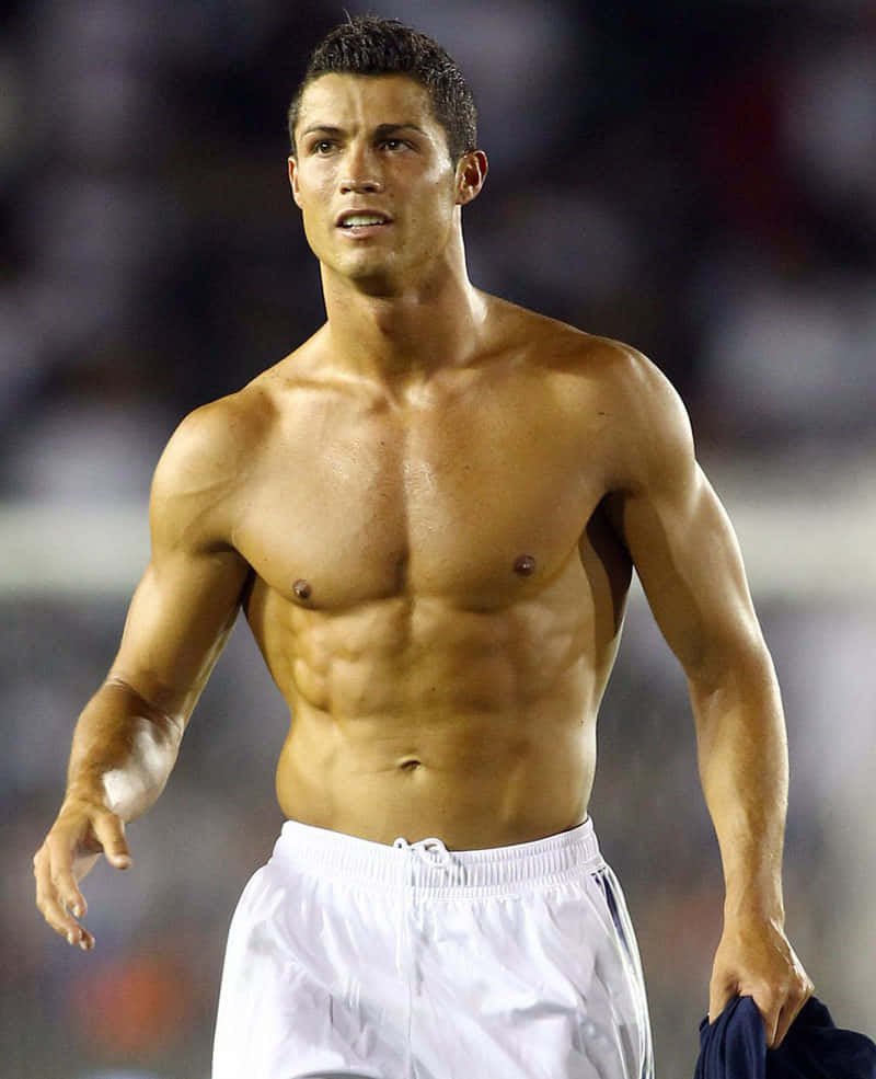 Download Cristiano Ronaldo striking a pose on the field | Wallpapers.com