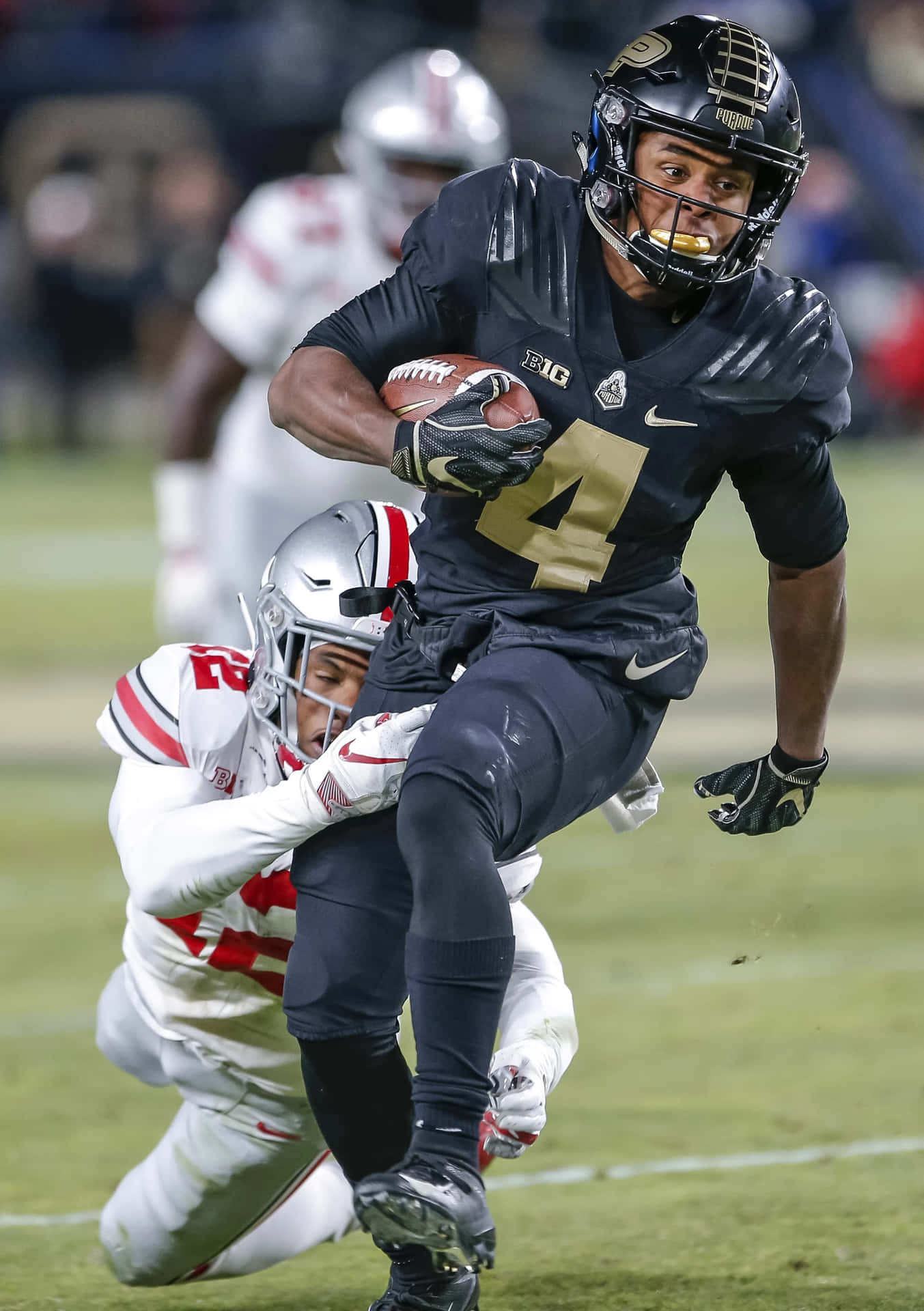 Rondale Moore Evading Tackle During Game Wallpaper