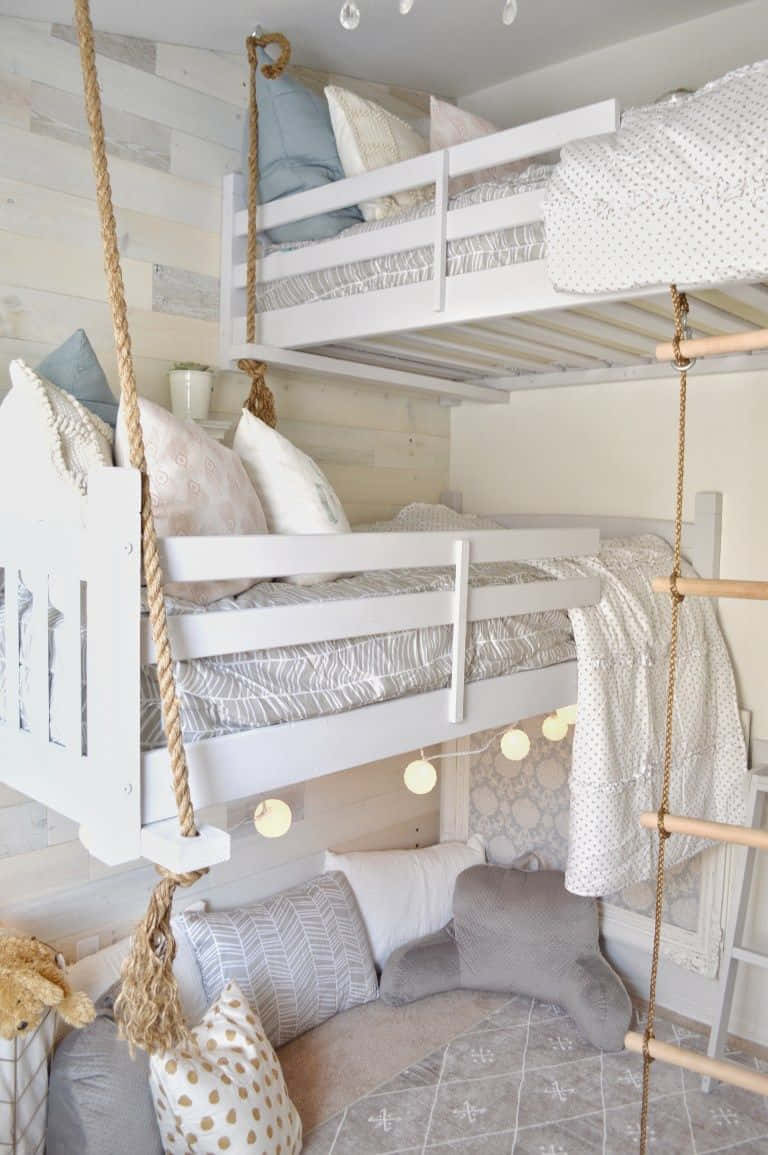 A White Bunk Bed With A Ladder Hanging From It