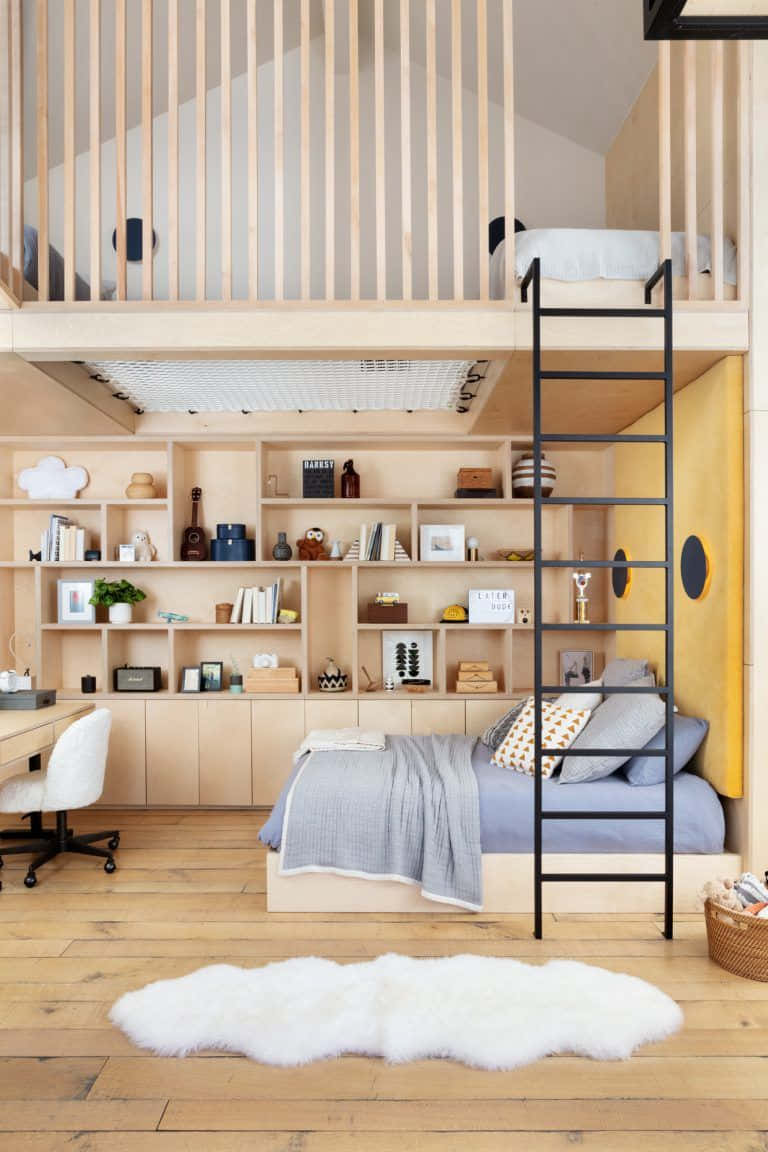 A Loft Bedroom With A Bed And Desk
