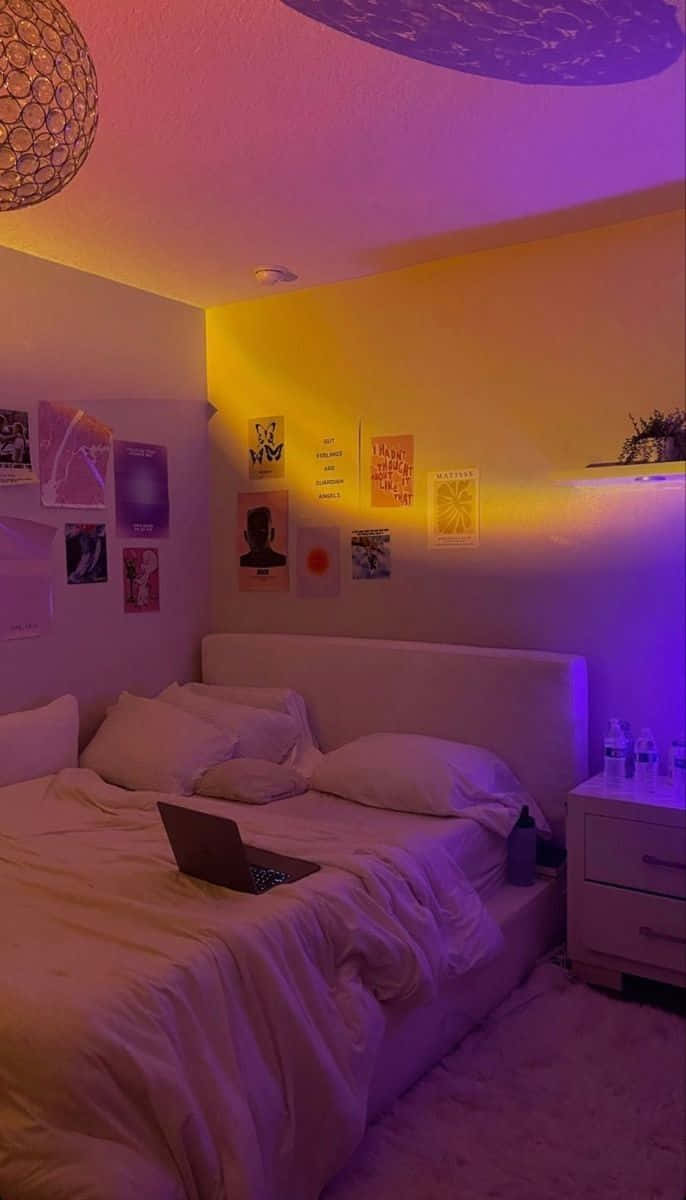 A Bedroom With A Bed And A Laptop On The Wall