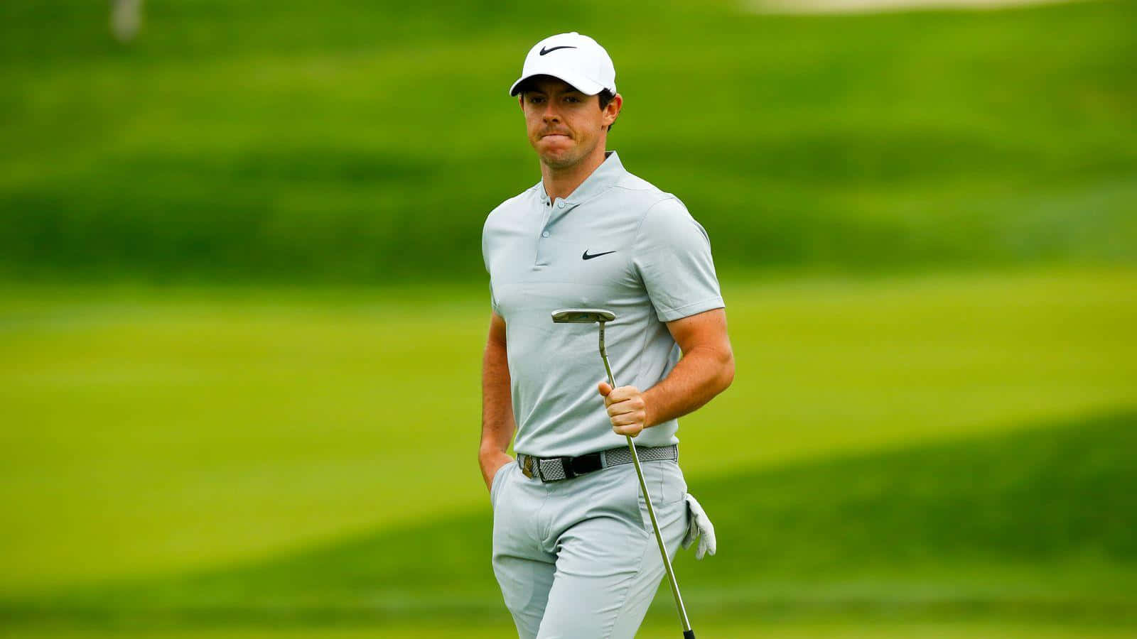 Professional golfer Rory McIlroy swings with precision Wallpaper