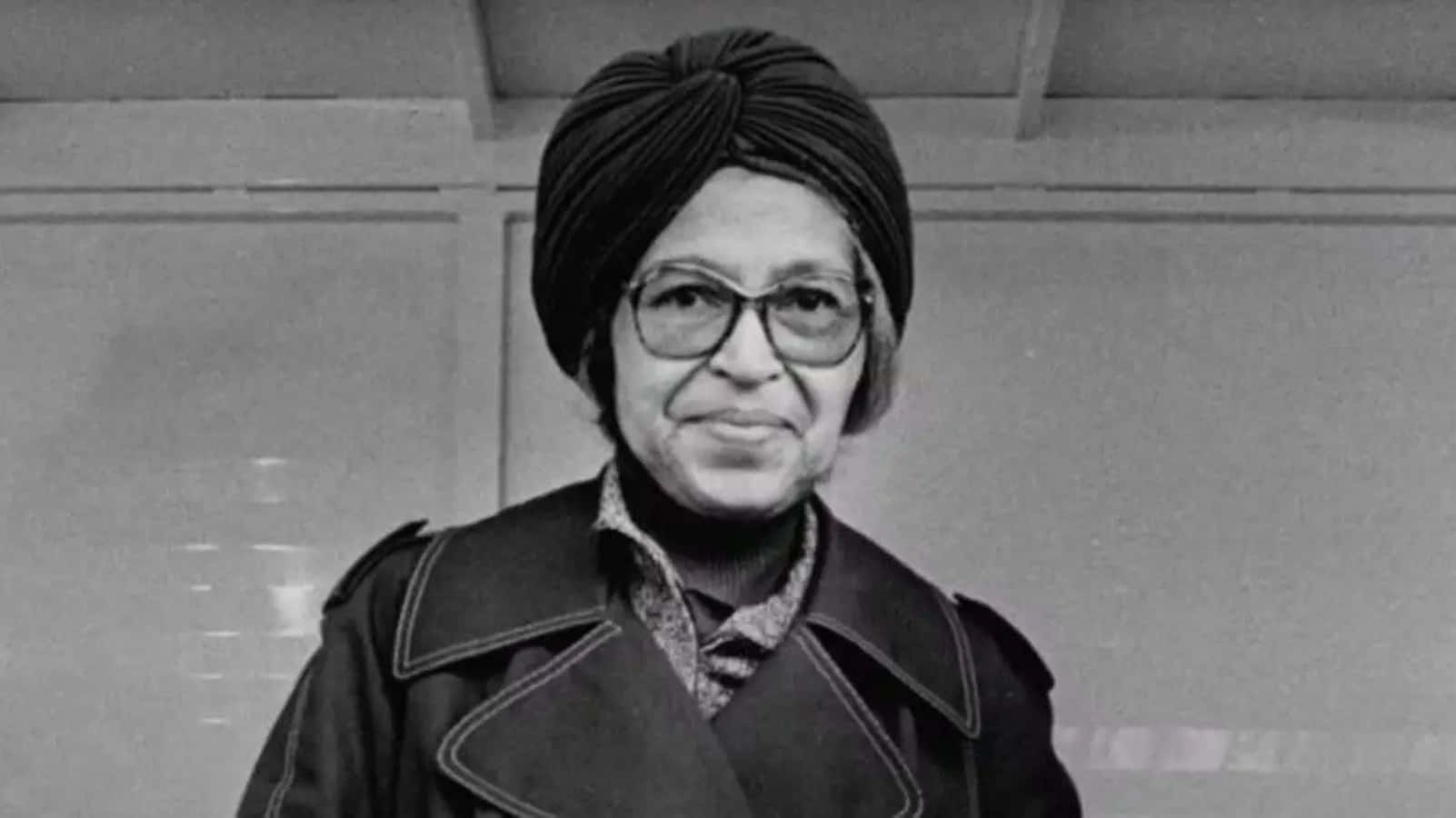 A Woman In A Turban And Glasses