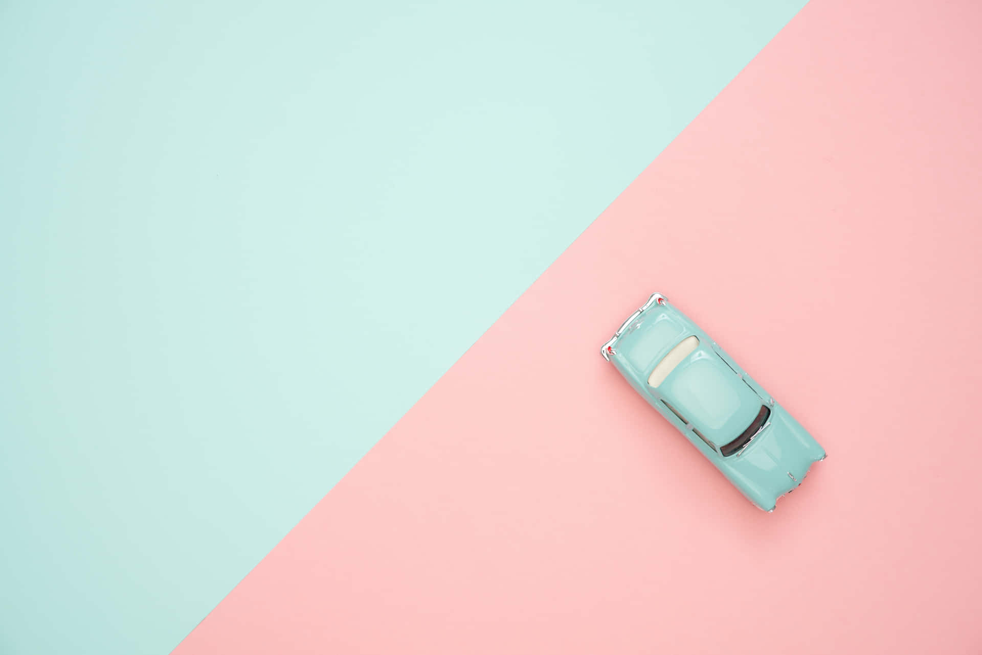 Spielzeugautoauf Pink-blauem Hintergrundbild