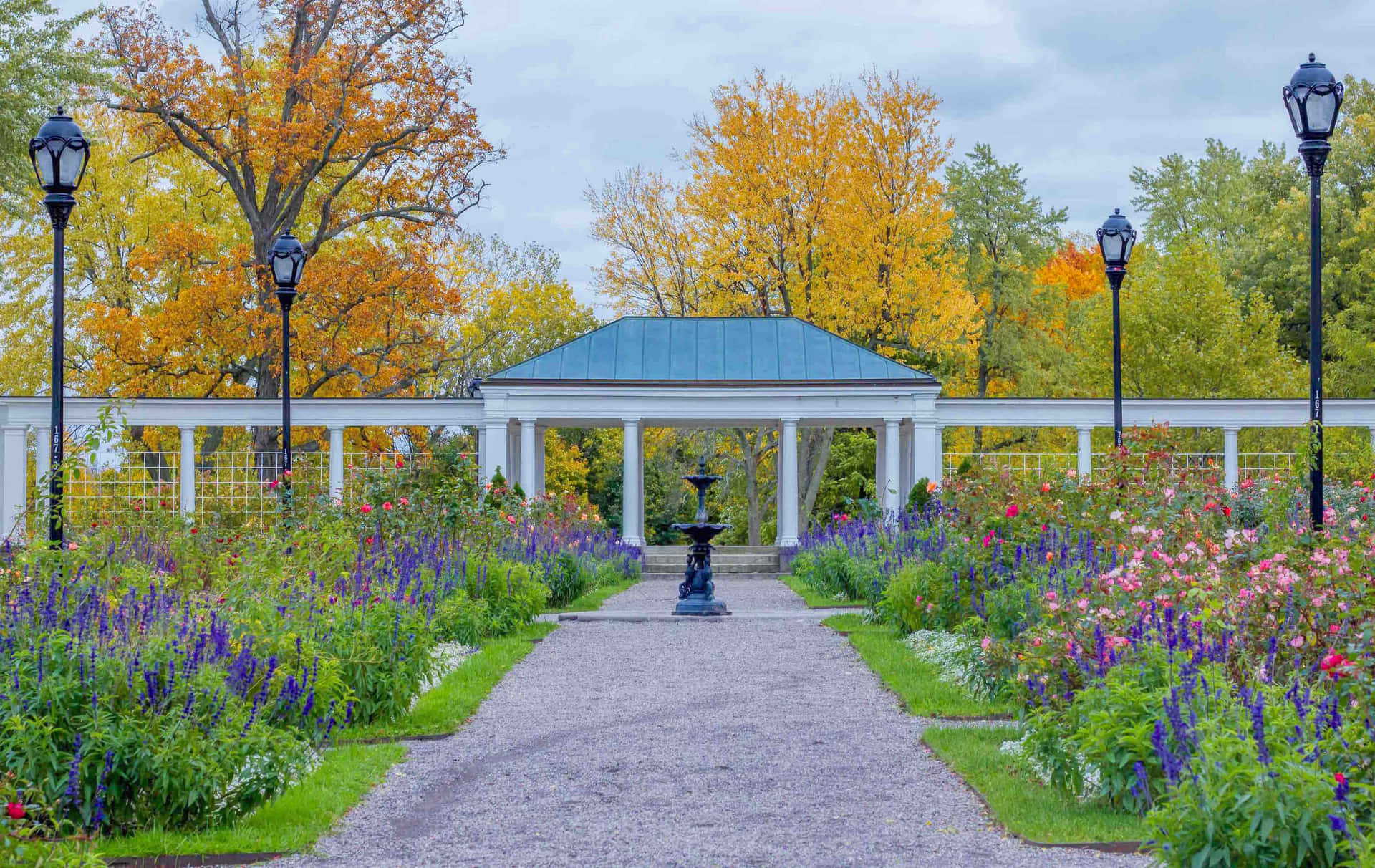 A Garden With A Gazebo And Flowers