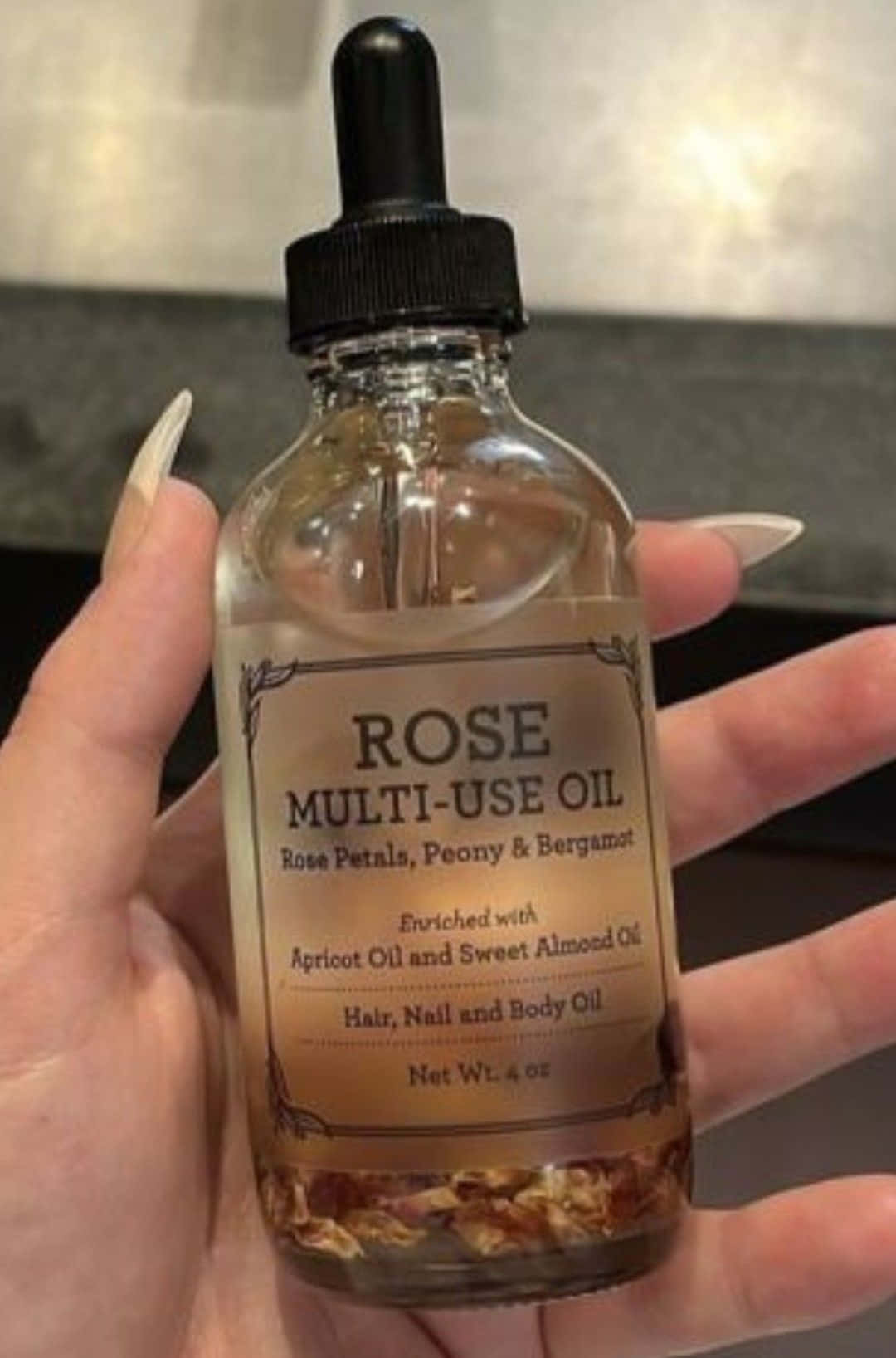 Luxurious Rose Oil in a Dropper Bottle Wallpaper
