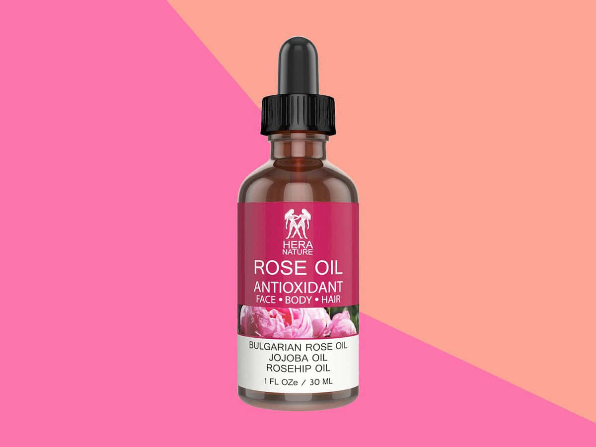 Luxurious Rose Oil in a Glass Dropper Bottle Wallpaper