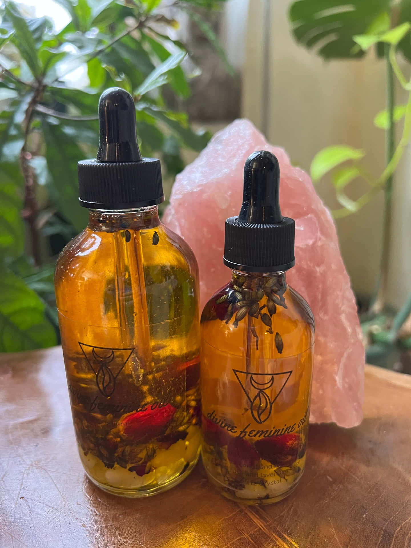 Aromatic Rose Oil in Glass Bottle with Fresh Roses Wallpaper