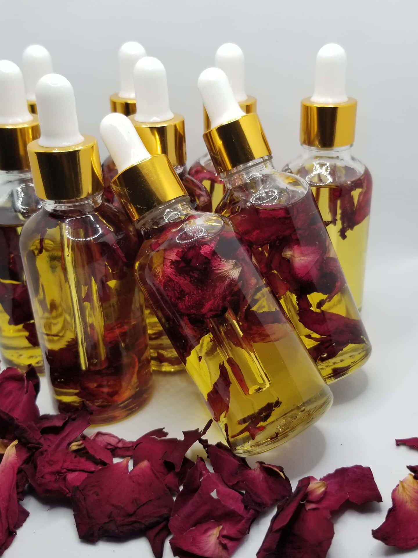 Beautiful Blooming Roses with Rose Oil Bottle Wallpaper