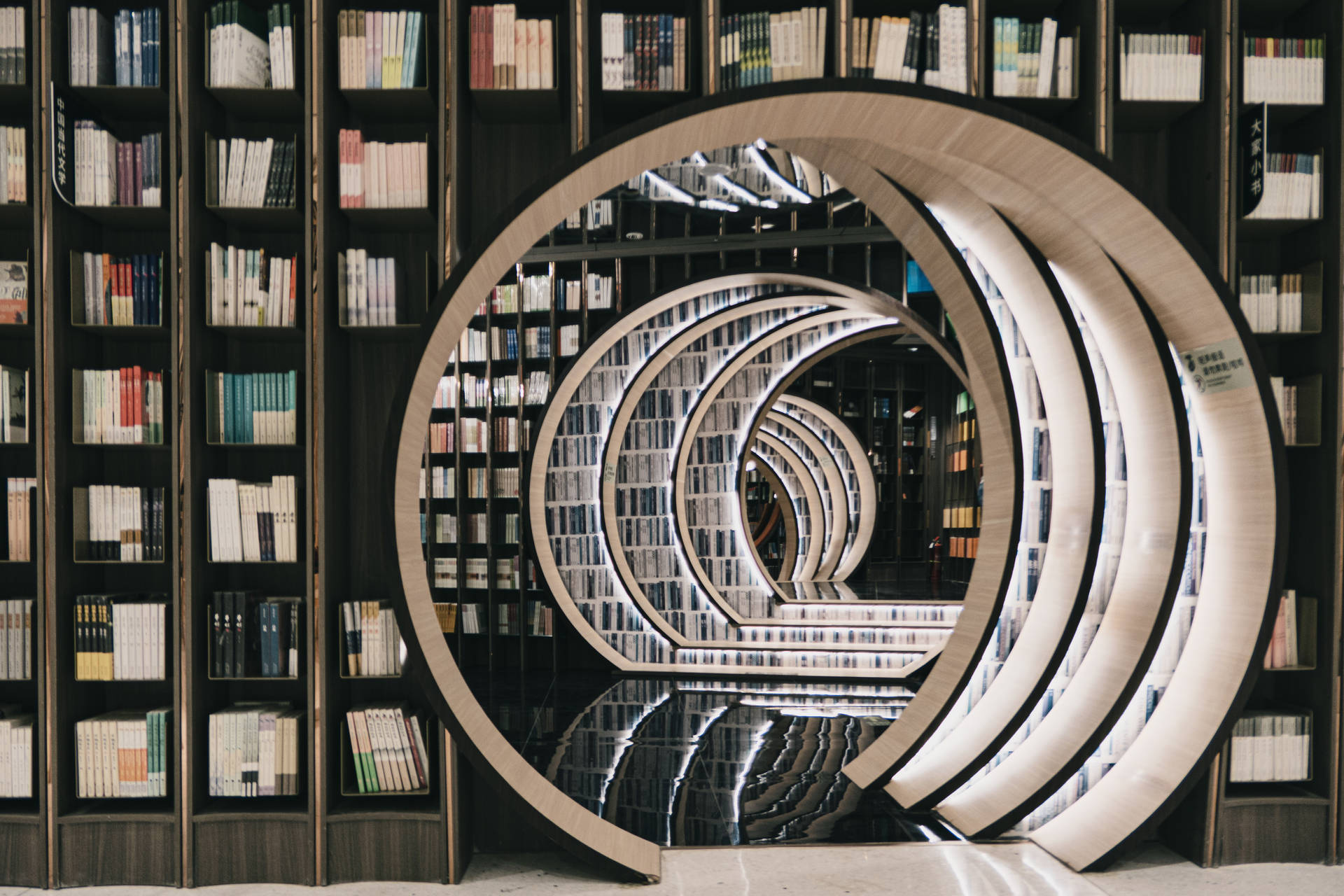 Round Bookshelf In Library Wallpaper
