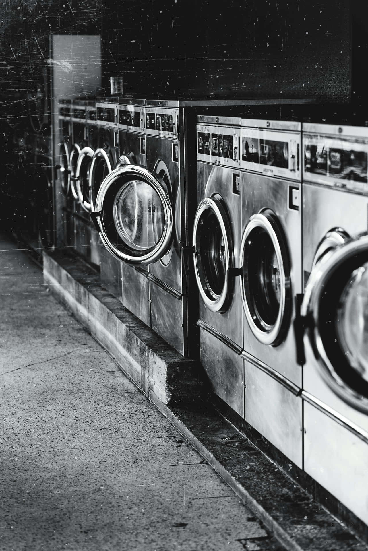 Rowof Washing Machinesin Laundromat Wallpaper