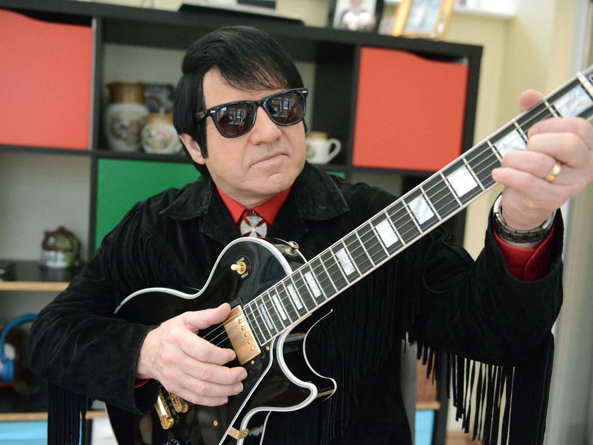Roy Orbison Playing His Guitar Wallpaper