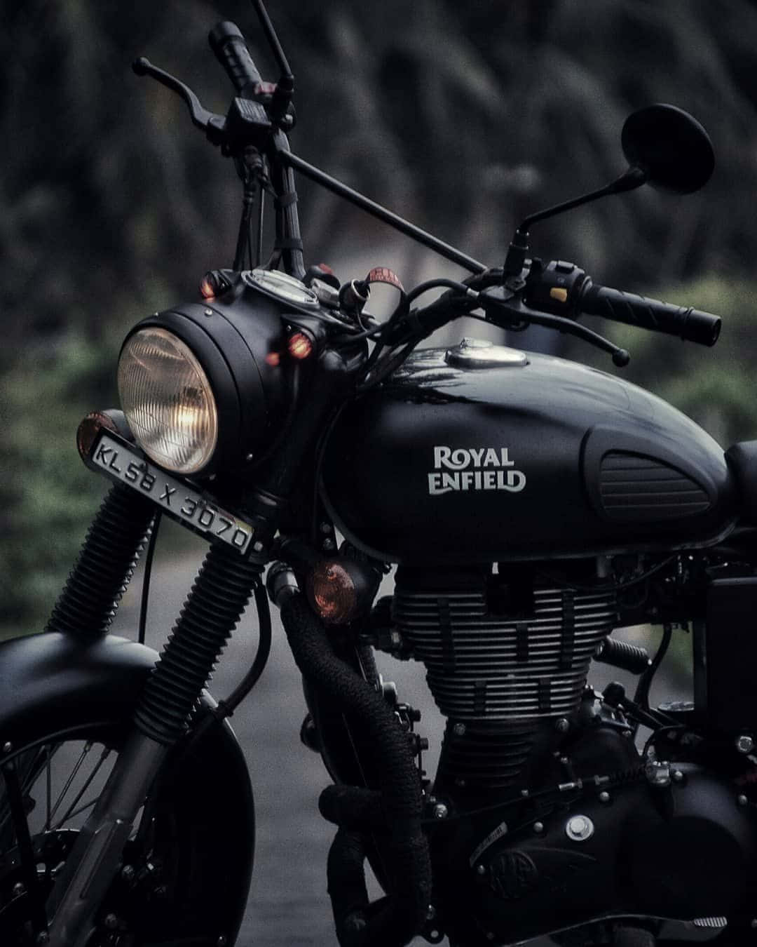 A Black Motorcycle With The Royal Emblem Parked On The Road
