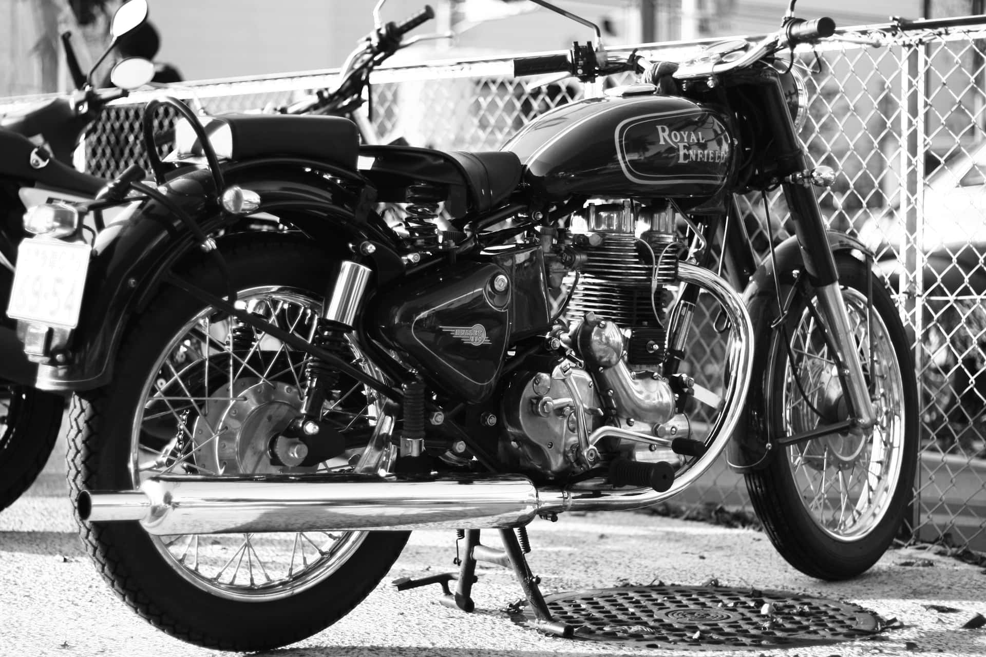A Black And White Photo Of Two Motorcycles