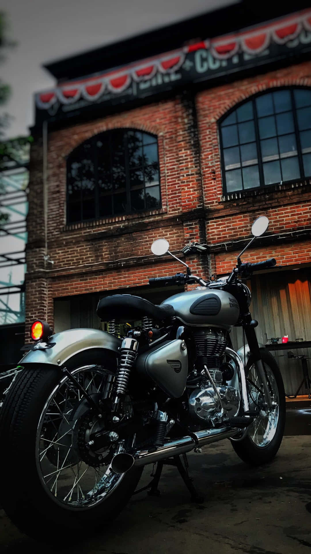 A Motorcycle Parked In Front Of A Brick Building