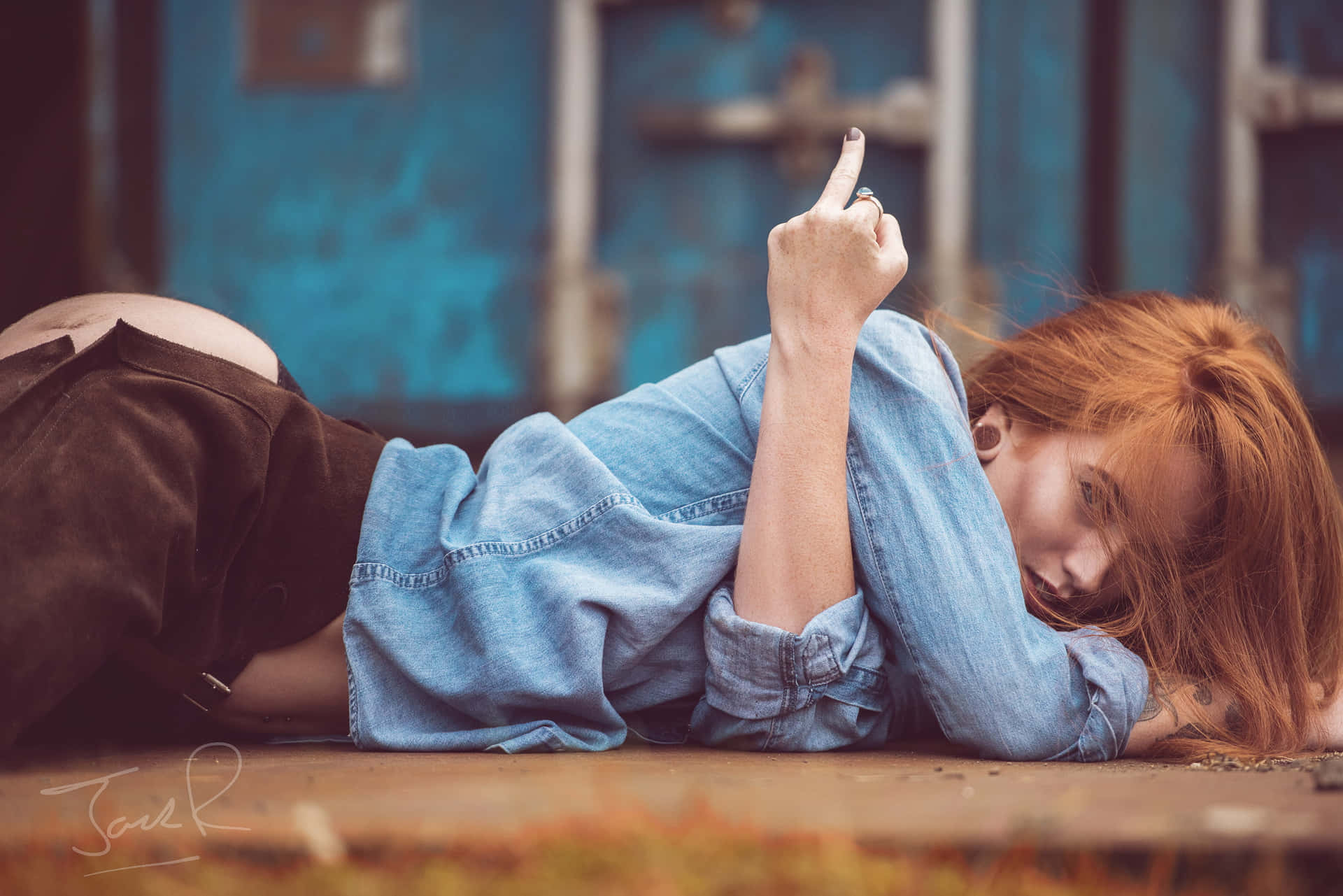 A Woman Laying On The Ground With Her Cigarette Wallpaper