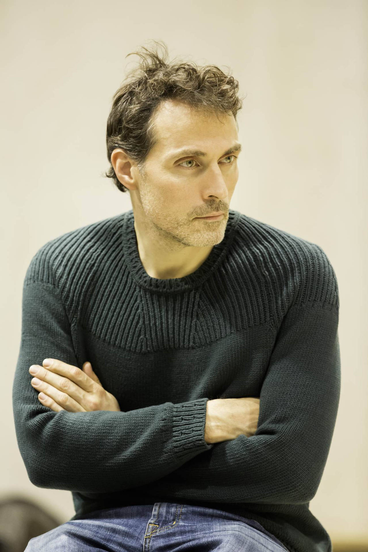 Rufus Sewell Posing with Crossed Arms in Black Sweater Wallpaper
