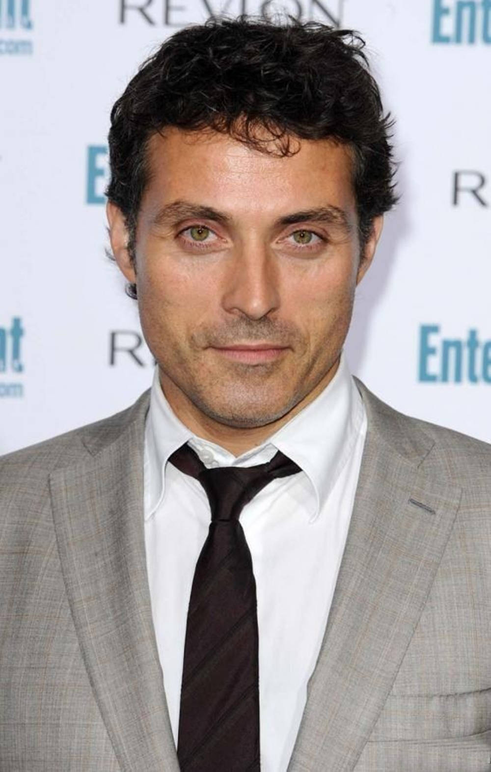Caption: Elegant Rufus Sewell in a Gray Suit and Black Tie. Wallpaper