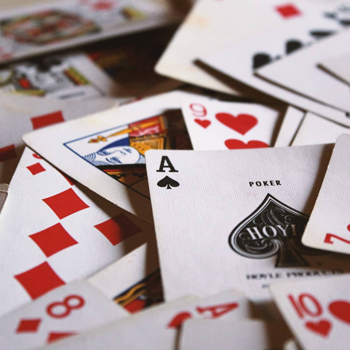 Rummy Playing Cards Shuffled On Table Wallpaper