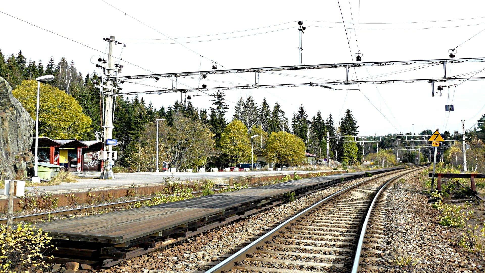 Download Rural Train Station Daytime Wallpaper | Wallpapers.com