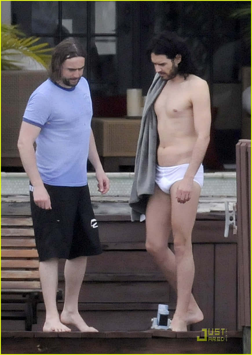 Comedian Russell Brand in an amusing pose wearing tighty whities. Wallpaper
