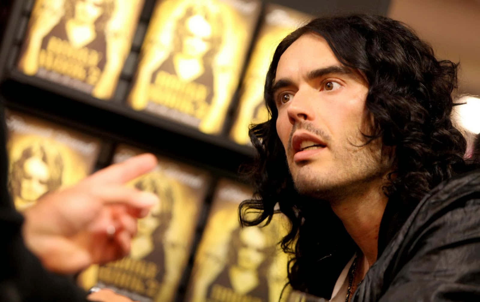 A captivating portrait of a young Russell Brand Wallpaper