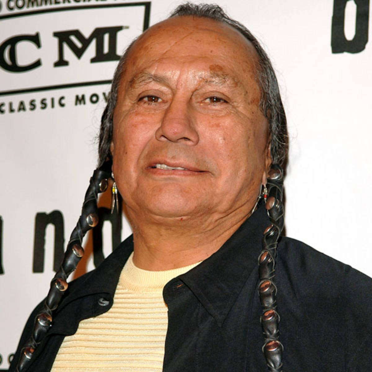 A Unique Photograph of Russell Means Showcasing His Inspirational Braided Hairstyle Wallpaper
