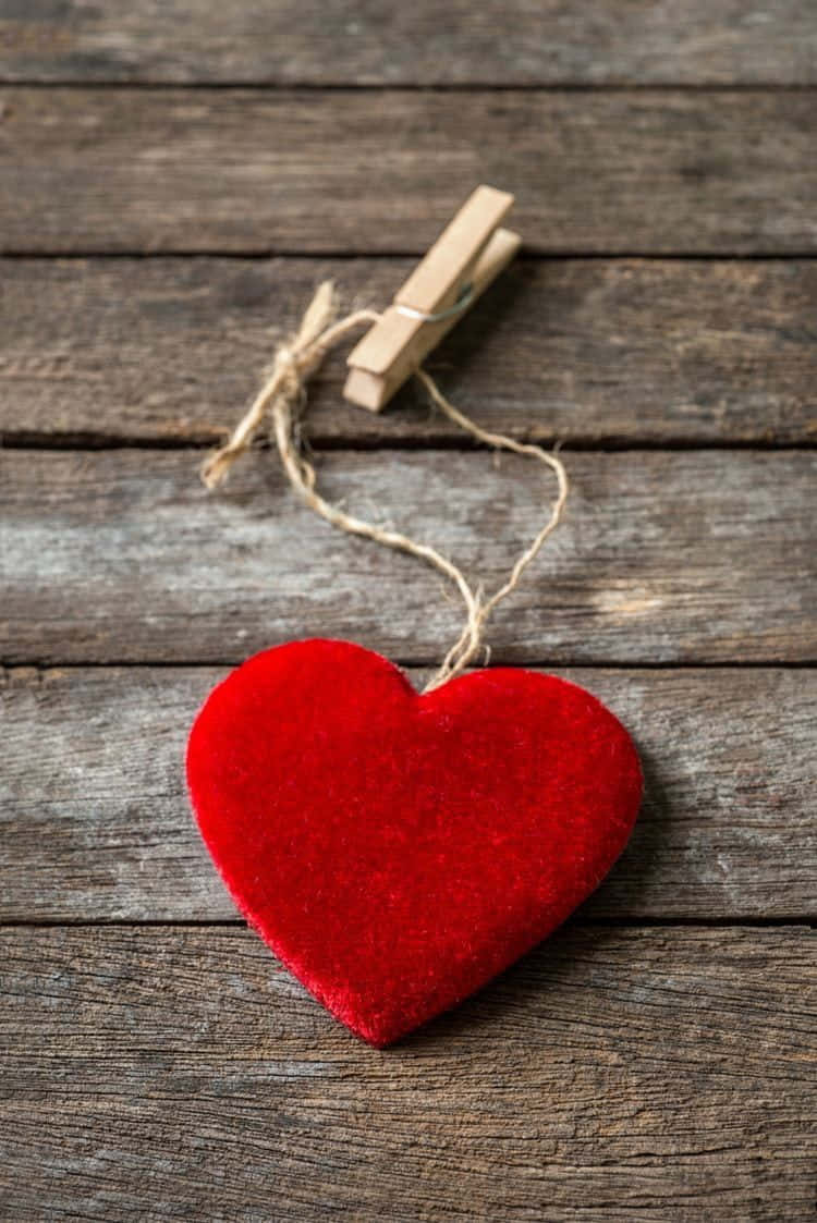 Red Heart Hanging On Wooden Background Wallpaper