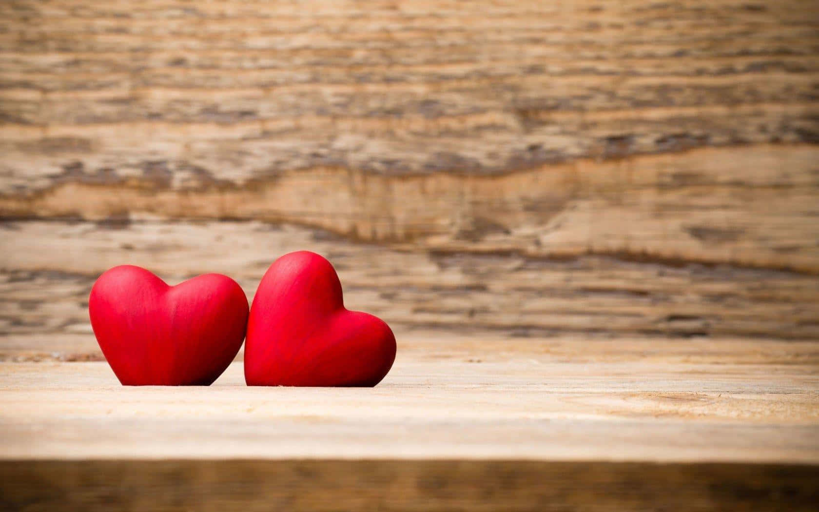 Two Red Hearts On A Wooden Table Wallpaper