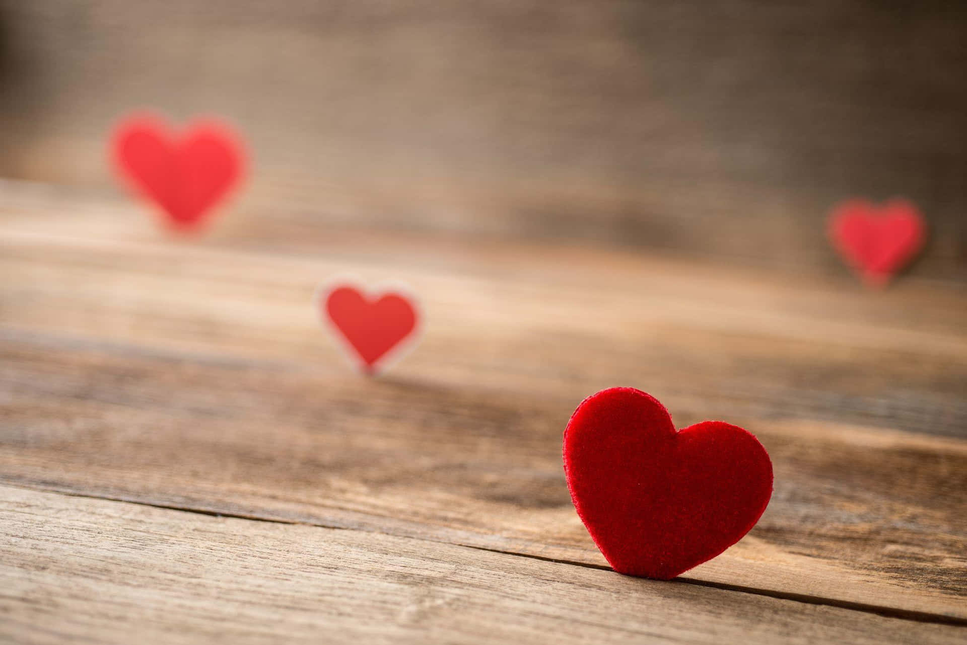 Red Hearts On A Wooden Table Wallpaper