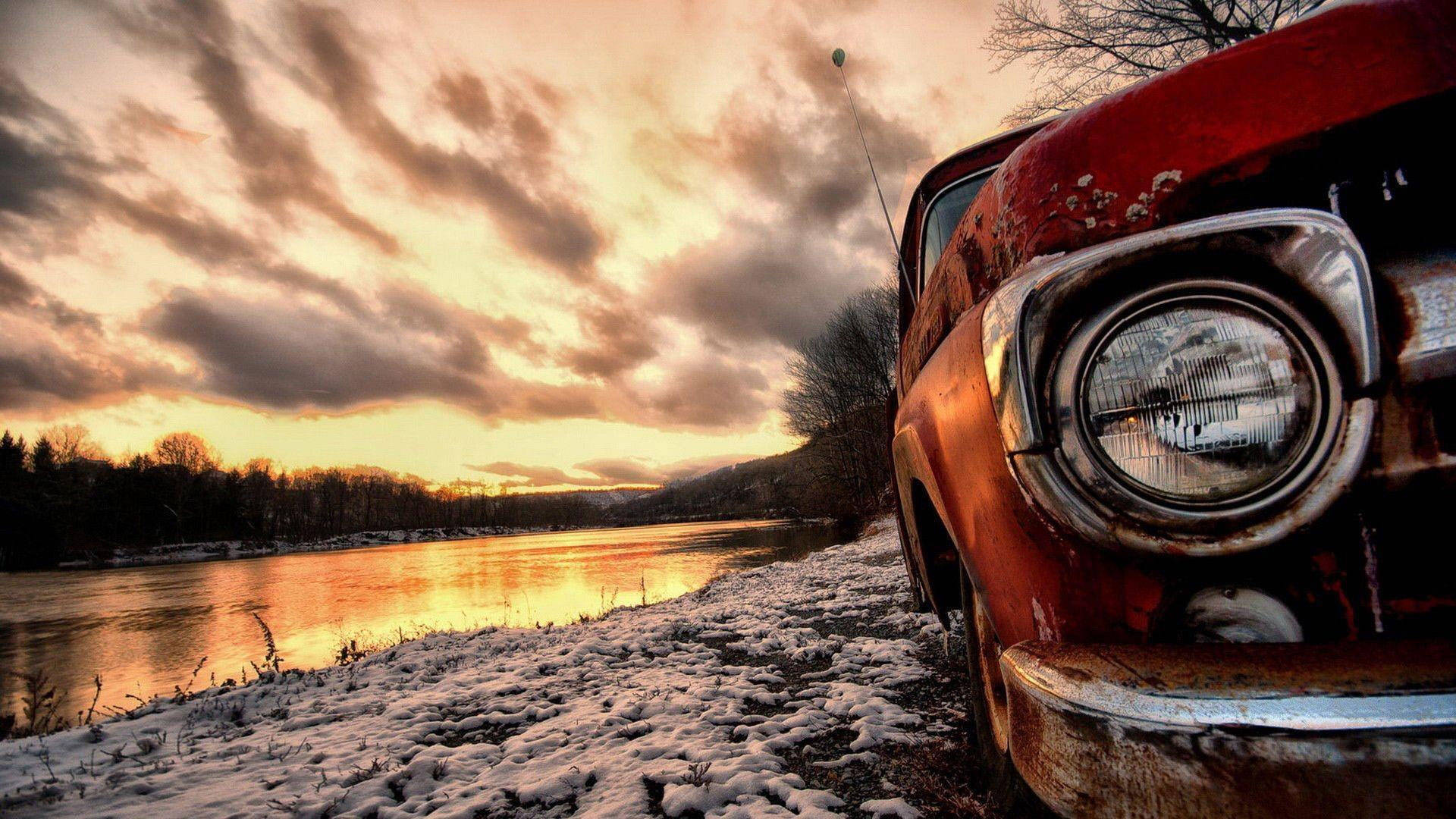 Rusty Old Car On The Riverside Wallpaper