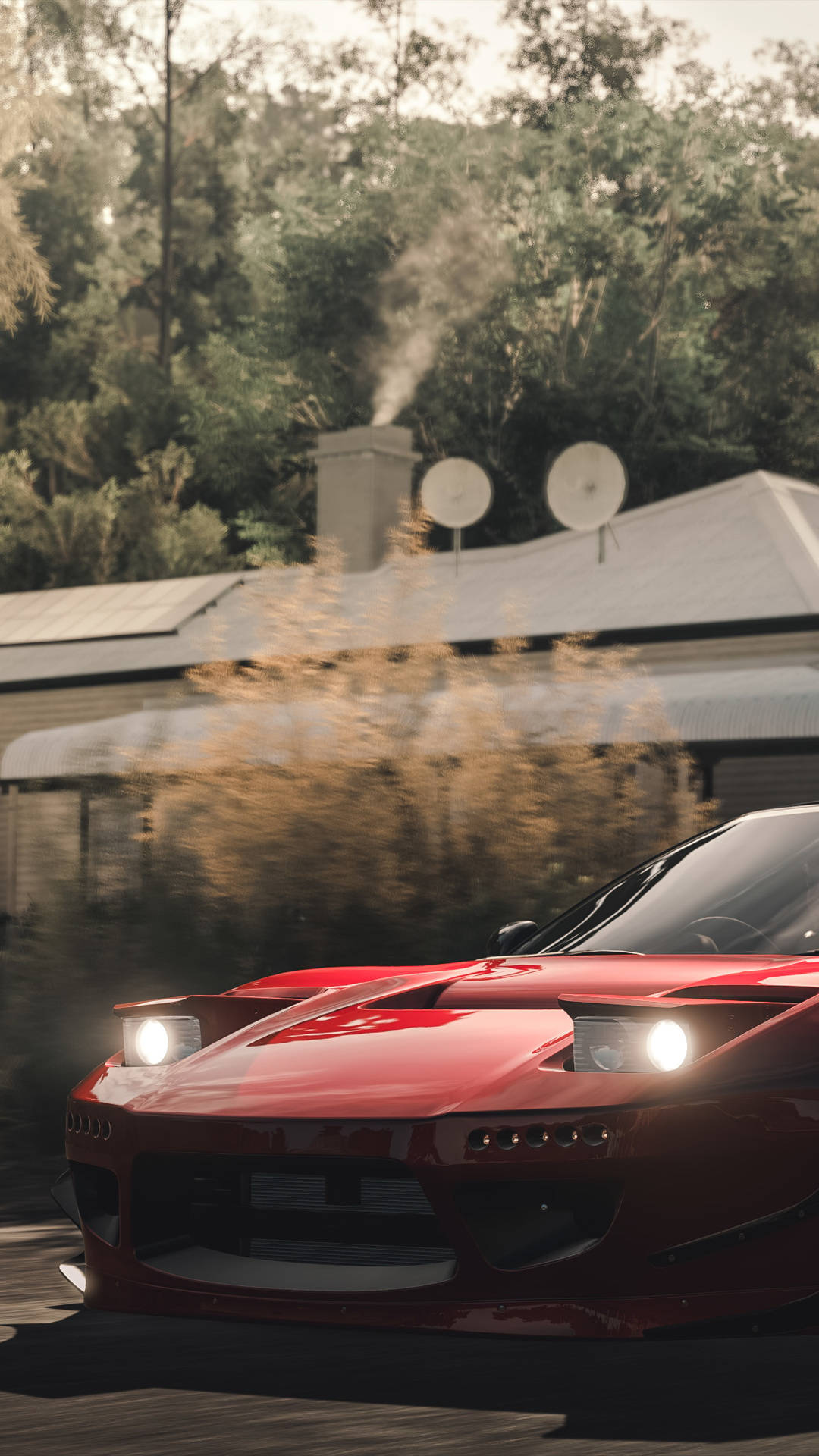 a red sports car driving down a road Wallpaper