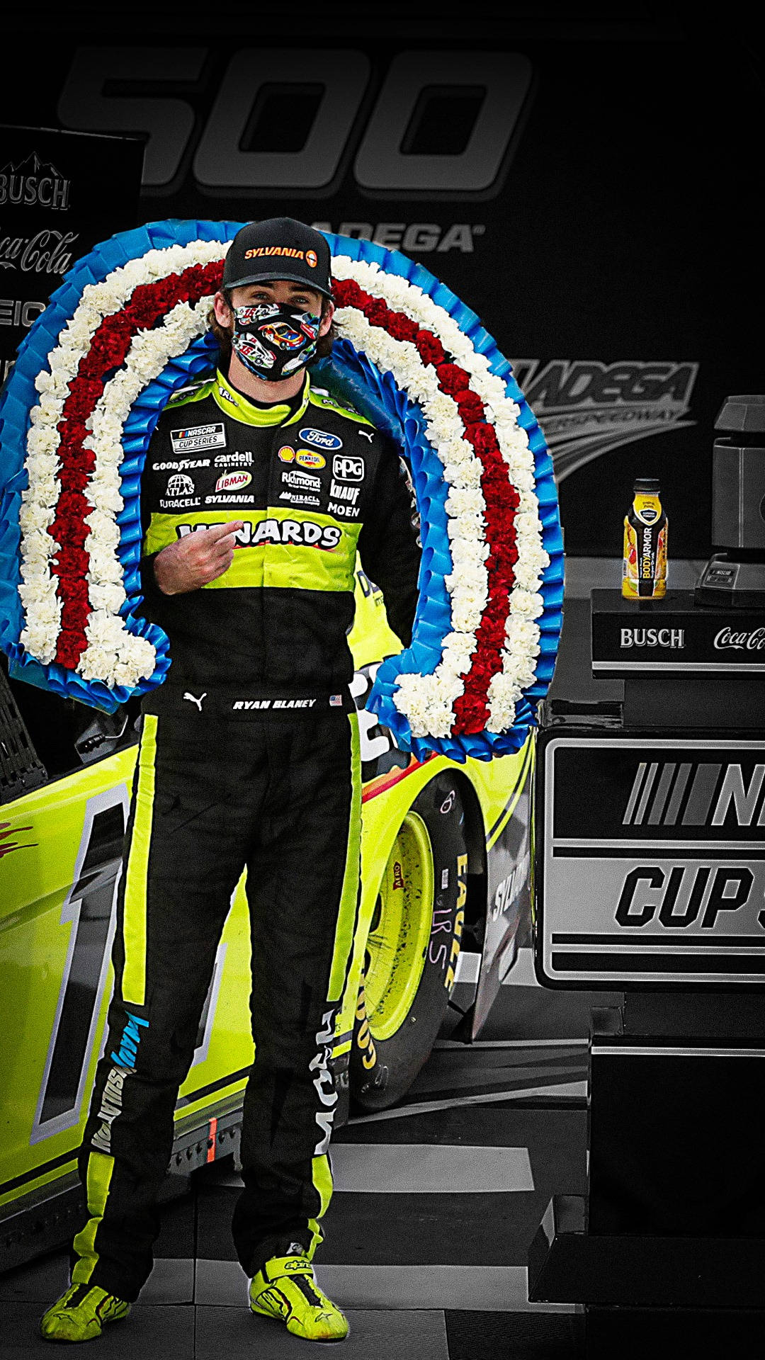 NASCAR Driver Ryan Blaney Posing with Red and White Flowers Wallpaper