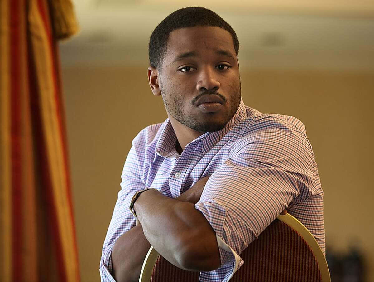 Ryan Coogler, the acclaimed director, smiling during an event Wallpaper