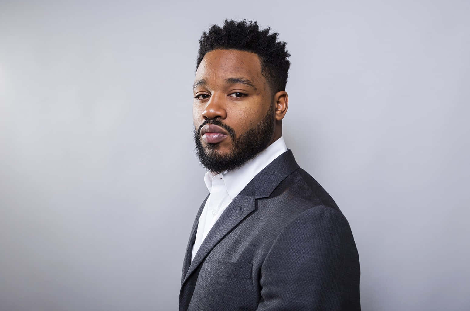 Ryan Coogler at a prestigious event looking confident and stylish Wallpaper