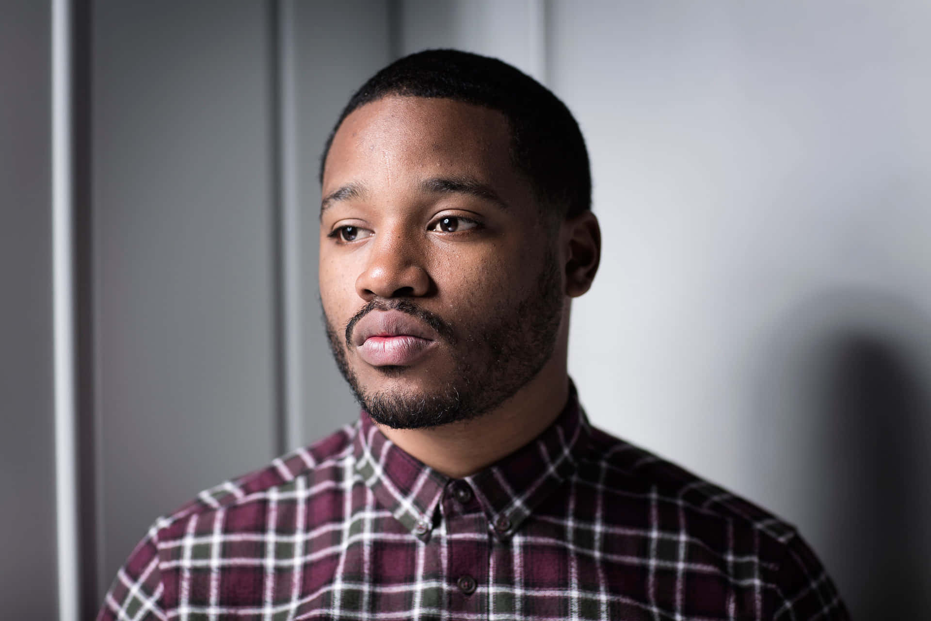 Ryan Coogler Poses at a Prestigious Event Wallpaper