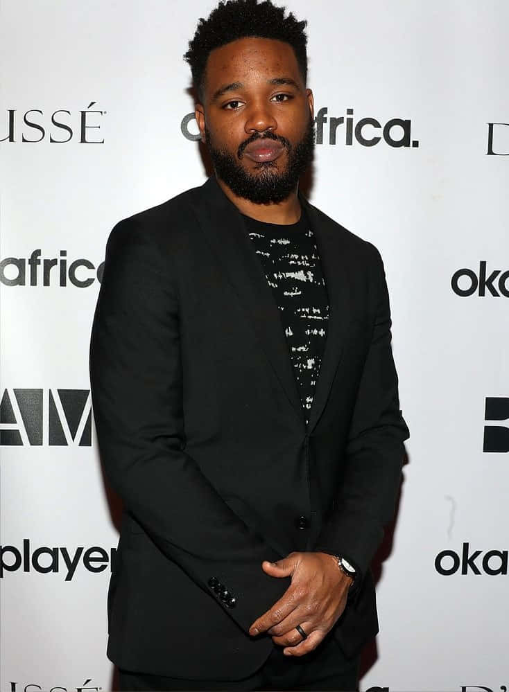 Ryan Coogler at an event, smiling for the camera Wallpaper