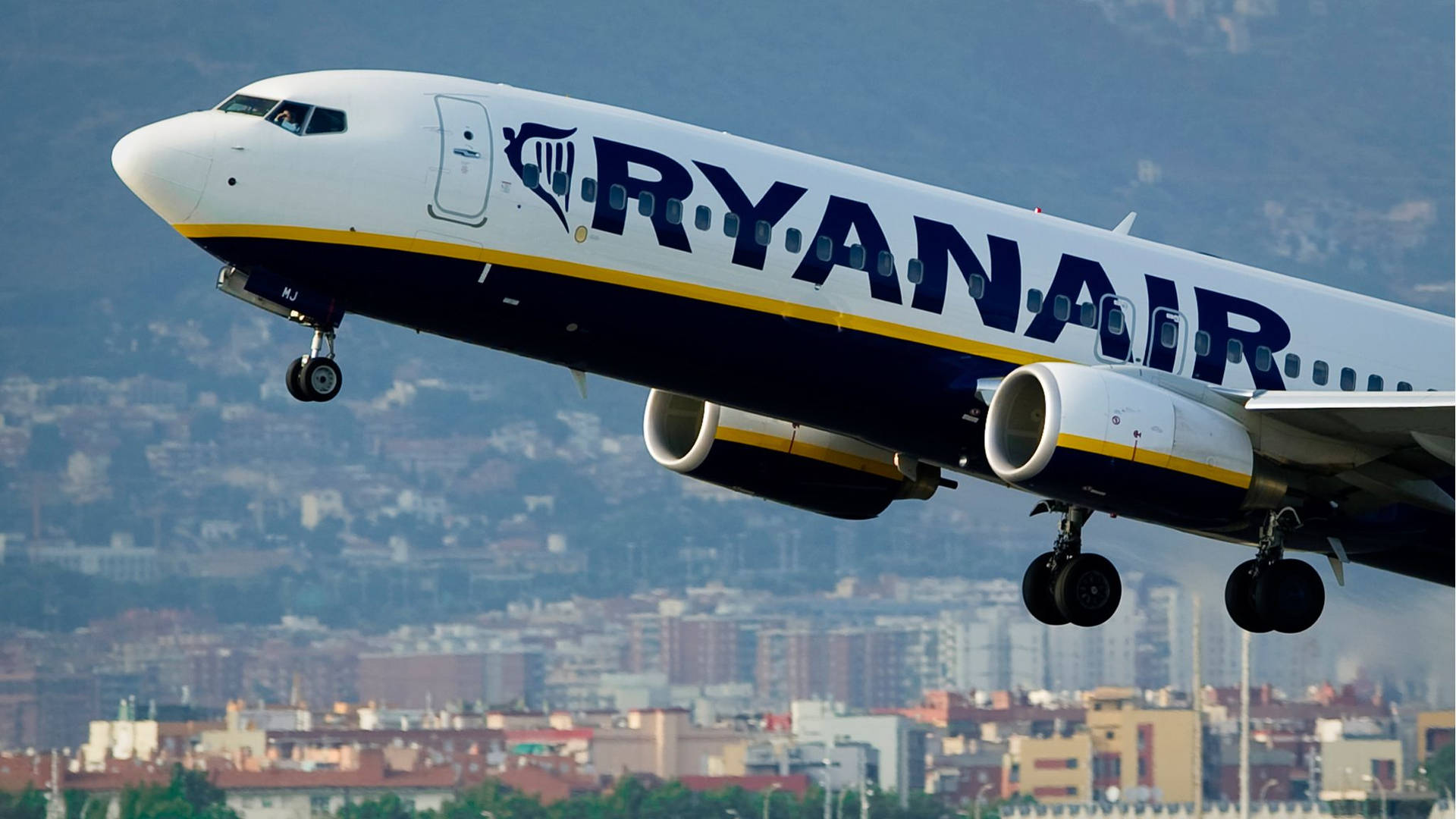 Ryanair Flying Over The City Wallpaper