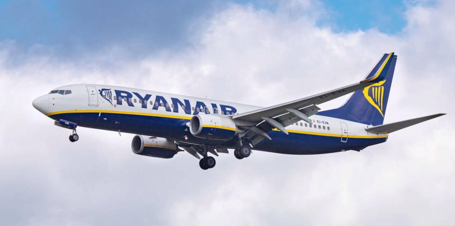 Ryanair Flying With Clouds Behind It Wallpaper