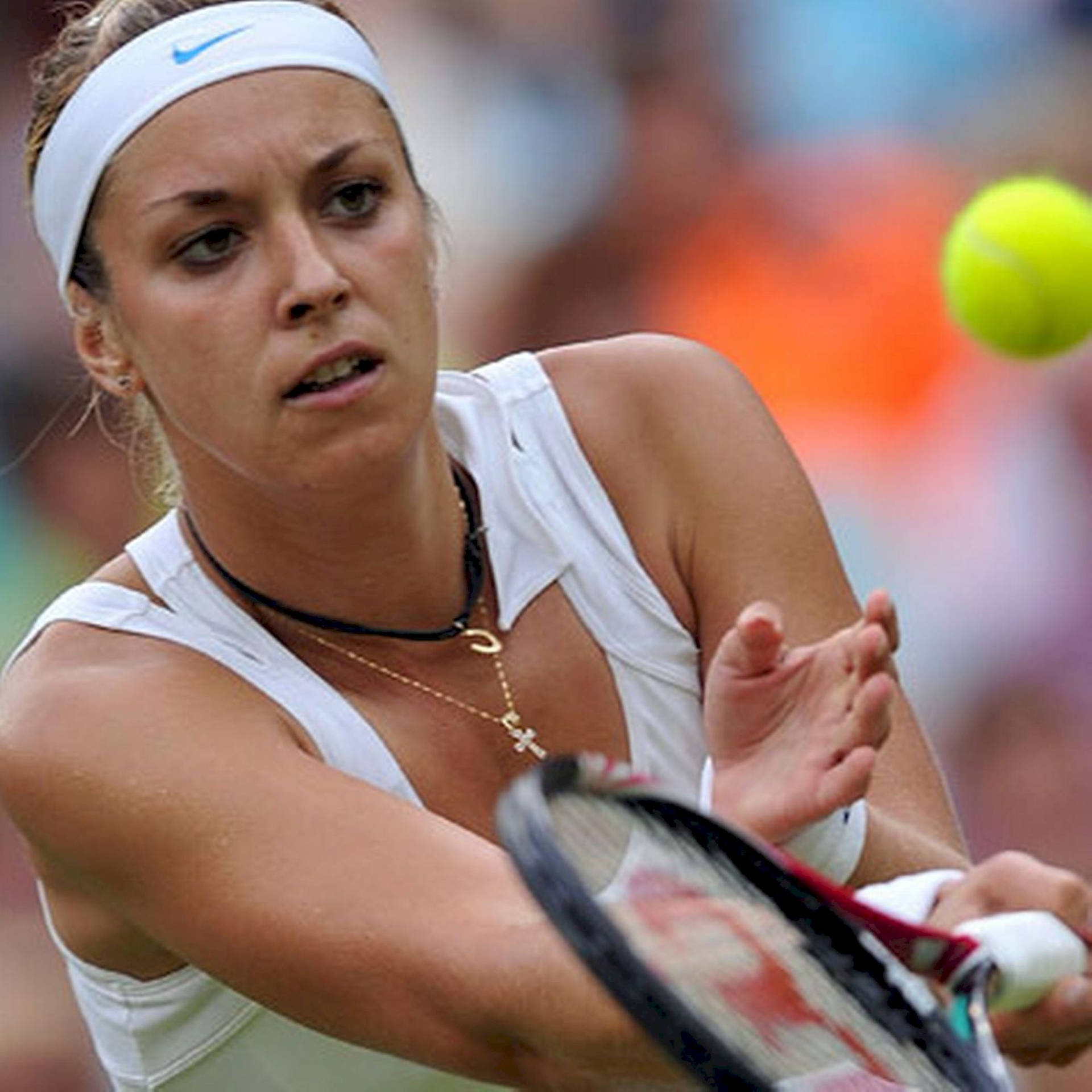 Sabine Lisicki dynamically catches the tennis ball on the court Wallpaper