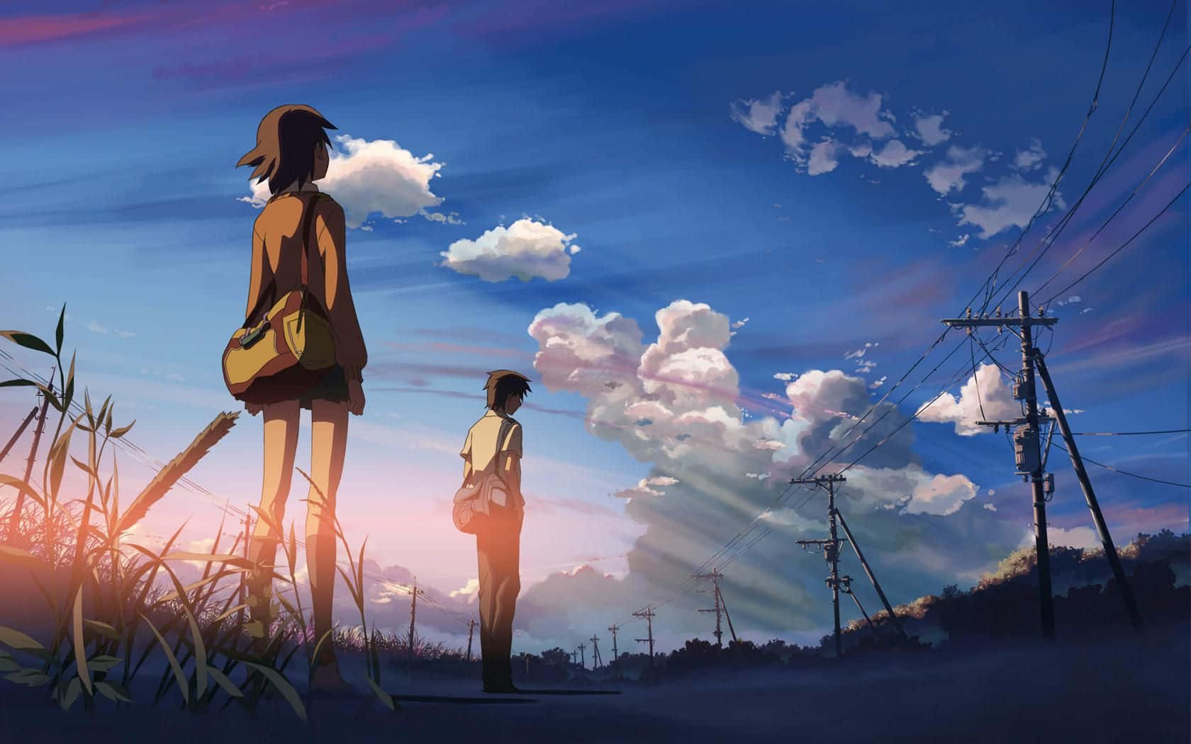 Two People Standing On A Field Looking At The Sky
