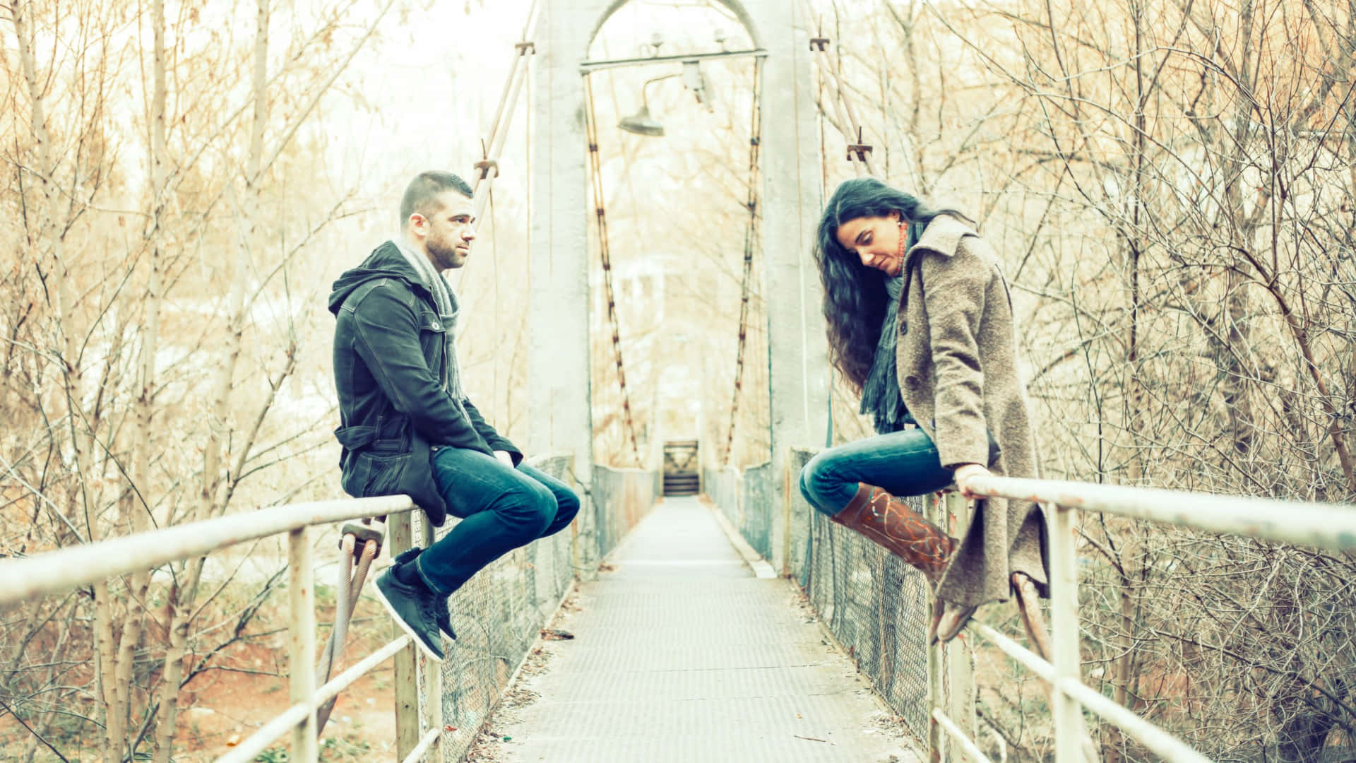 Download Sad Couple Sitting On The Bridge Wallpaper 