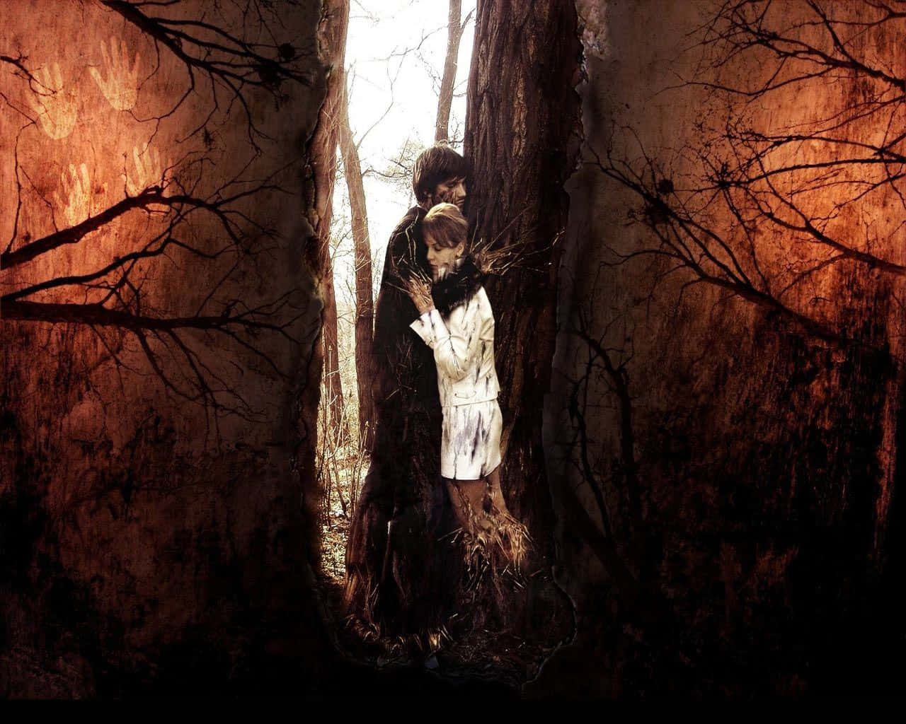 A Dejected Couple Amidst Enchanting Yet Spooky Trees Wallpaper