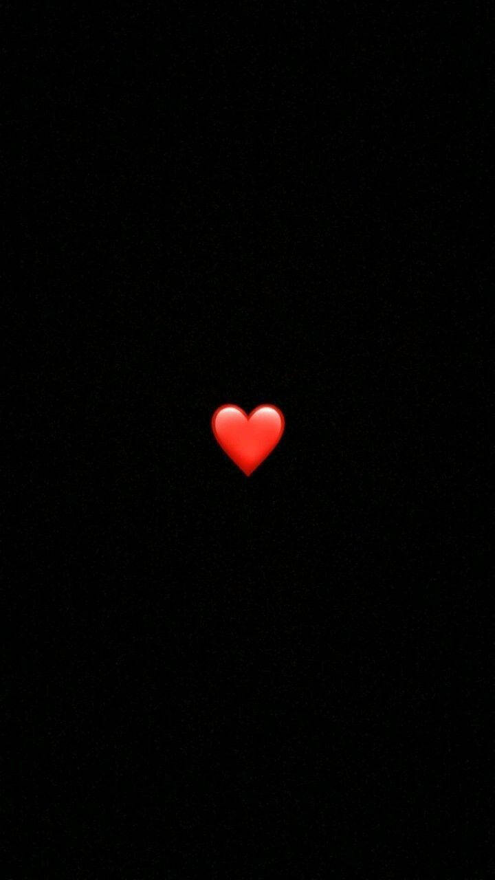 A Red Heart Is Lit Up In The Dark Wallpaper